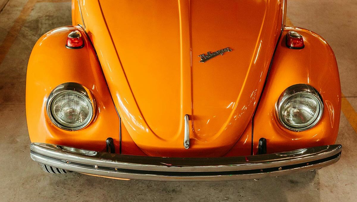 Photo by Jonathan Borba: https://www.pexels.com/photo/front-of-an-orange-volkswagen-beetle-18426374/