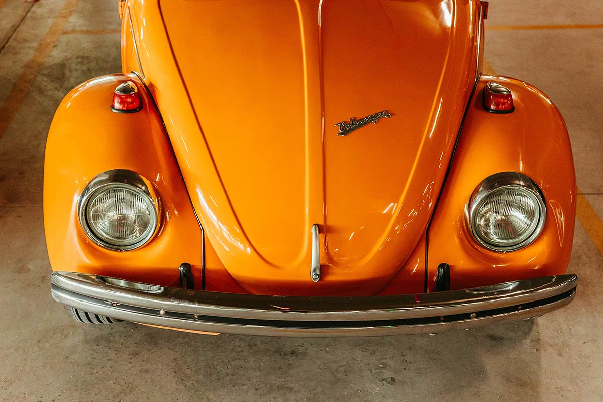 Photo by Jonathan Borba: https://www.pexels.com/photo/front-of-an-orange-volkswagen-beetle-18426374/